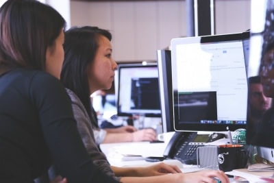 two co-workers on the computer