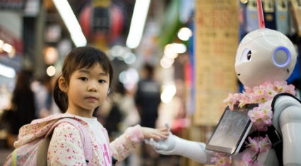 a little girl interacting with a robot