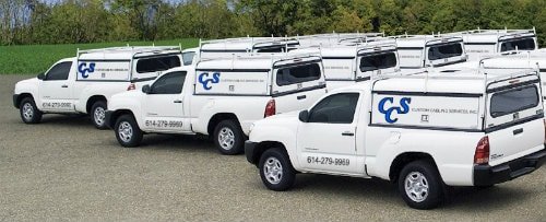 A fleet of custom cabling services trucks